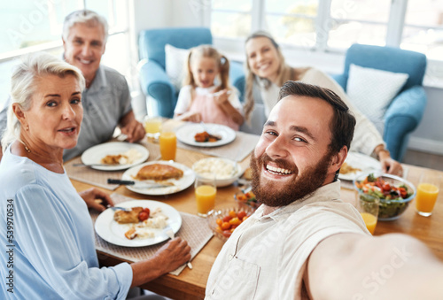 Love, selfie and food with big family in home for cheerful photograph together in Australia. Parents, grandparents and child at lunch dining table with happy smile for picture memory in house.