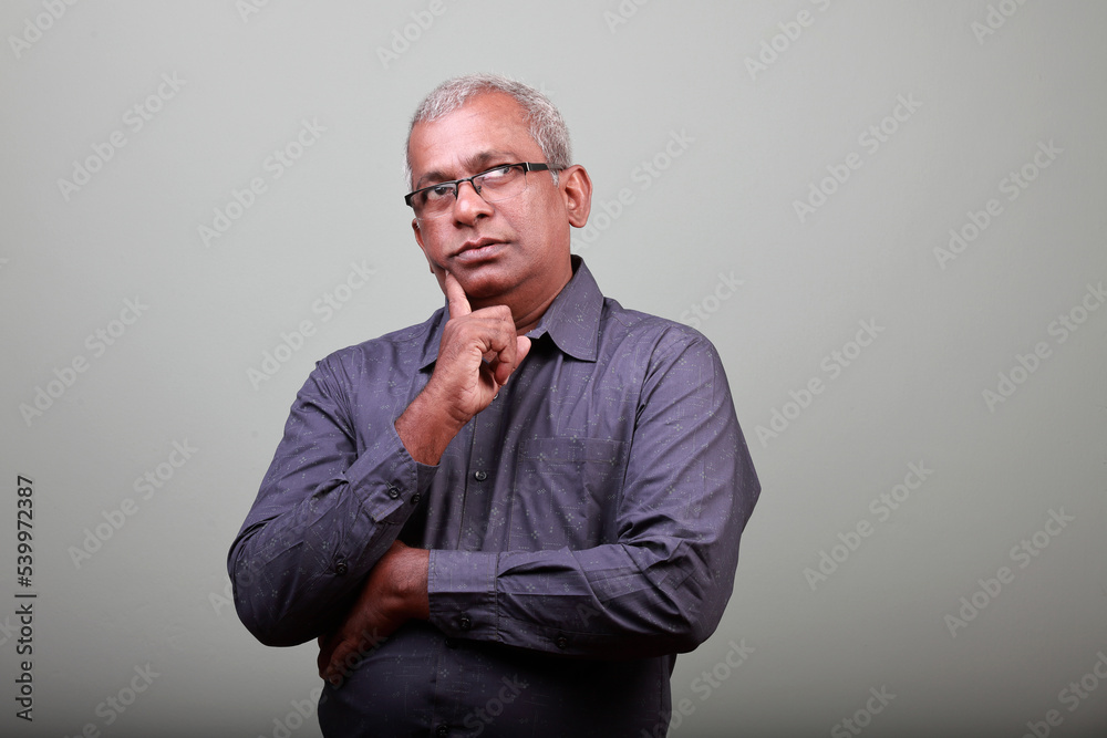 Portrait of a senior man of Indian ethnicity a thinking face Portrait of a senior man of Indian ethnicity a thinking face
