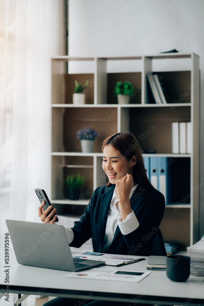 Happy excited young Asian woman with a laptop at home sitting in-home office, Emotional girl feeling glad and happy Happy excited young Asian woman with a laptop at home sitting in-home office, Emotional girl feeling glad and happy