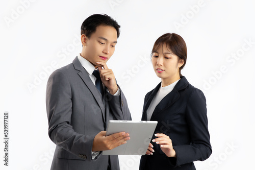 Asian businesspeople man and woman looking at lablet on white background. 