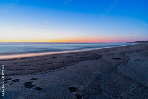 Blue hour after sunset on the beach and sea