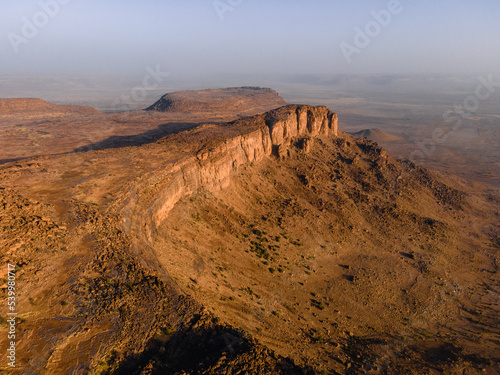A huge rock cliff and canyon near Kamour, Mauritania, Sahara Desert photo