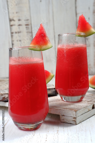 Fresh watermelon juice,on white table.Sweet summer dessert, smoothie,cocktail healthy food concept, close up.Summertime
