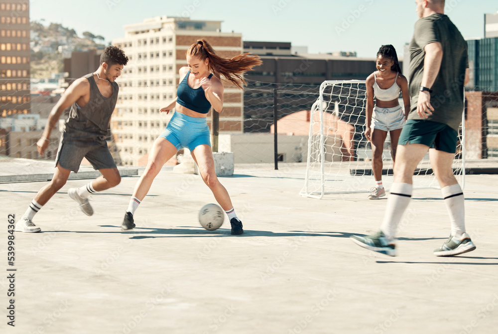 Soccer, rooftop and friends happy activity bonding together with sport workout training in city. Diversity, sports and men and women, football competition exercise and healthy lifestyle motivation