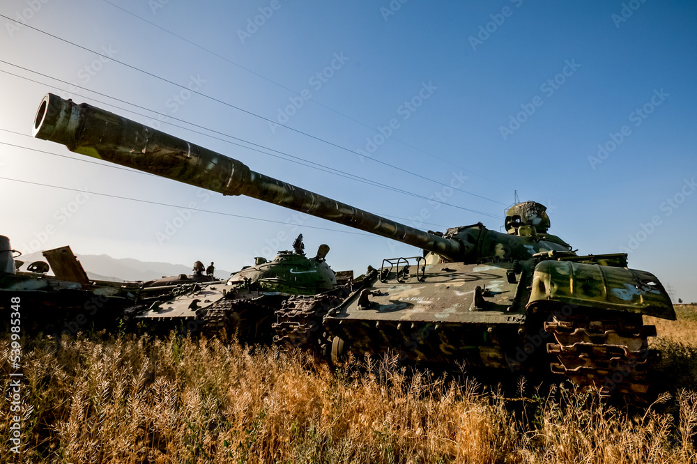 Fototapeta premium War in Afghanistan. The road to Jalal-Abad in Afghanistan and the cemetery of military equipment