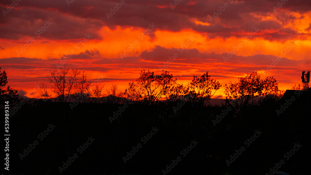 Incredibly colorful and bright sunset on the background of residential buildings. Incredibly colorful and bright sunset on the background of residential buildings.