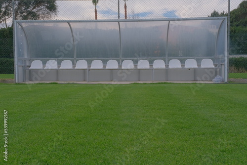 a bench on the green field