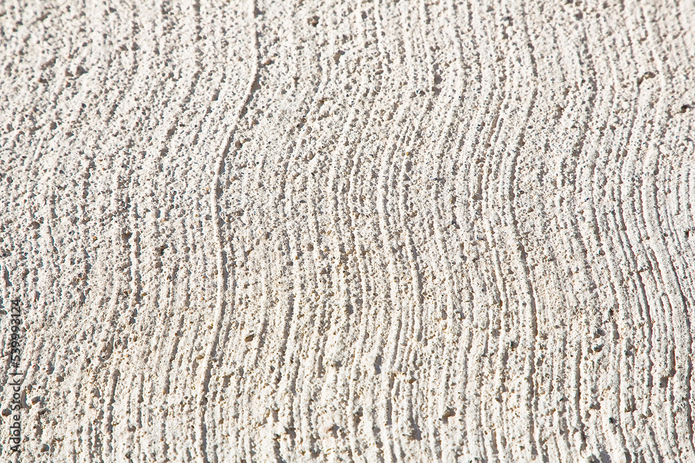New concrete roadbed background made with cement and stone gravel with a striped finish
