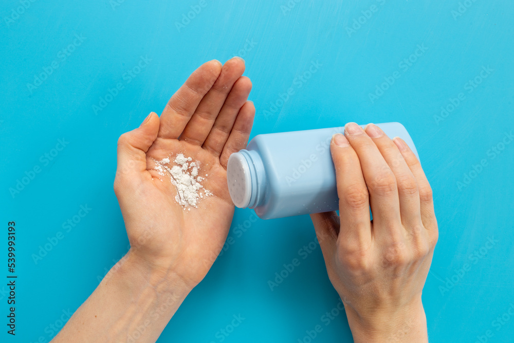Woman applying baby talcum powder on hand. Skin care cosmetic Woman applying baby talcum powder on hand. Skin care cosmetic