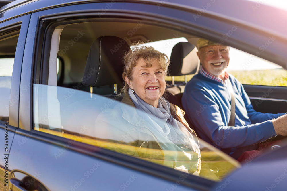 Senior couple driving a car 
