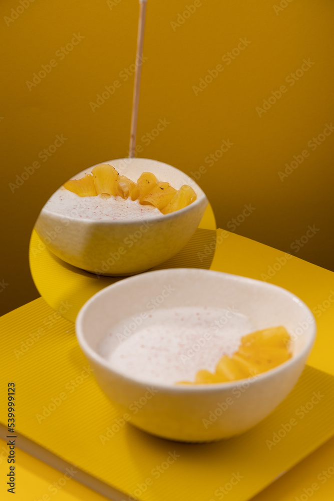 porridge with pineapple on a yellow background porridge with pineapple on a yellow background