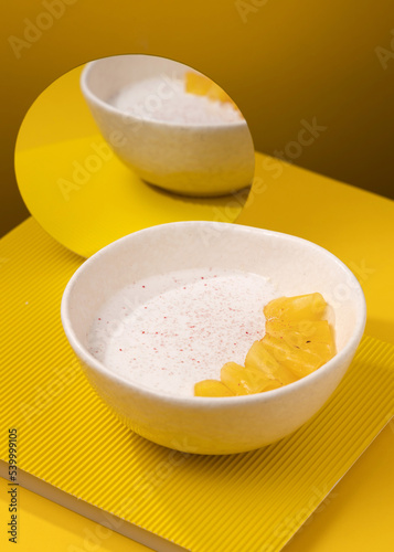 porridge with pineapple on a yellow background