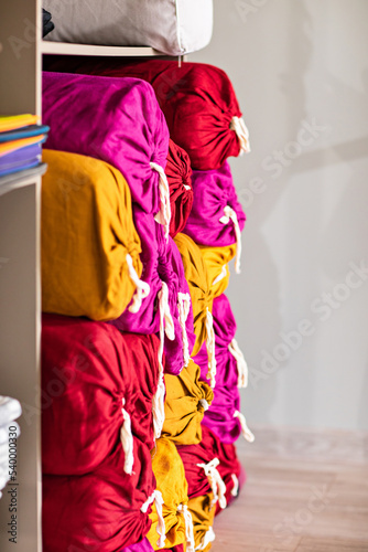 A bolster on a shelf in the gym closet. A special yoga roller.