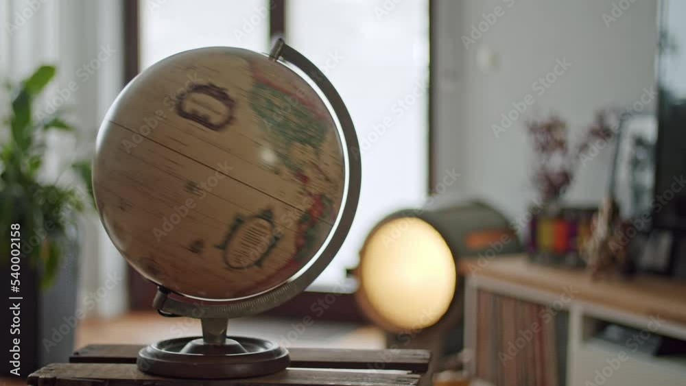 Vintage globe spinning in a home setting.