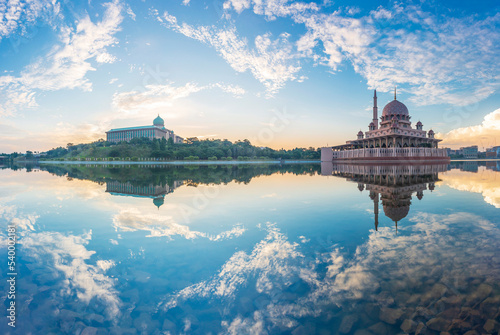 Beautiful sunrise At Putra Mosque, Putrajaya Malaysia with colorful clouds and reflection on the lake surface. photo