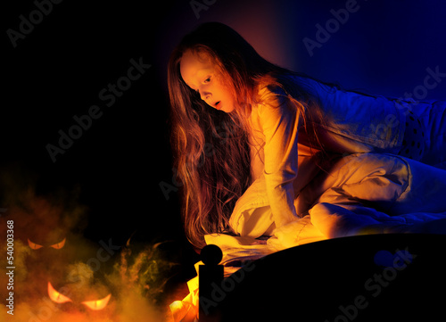 Little girl having nightmares of monsters under the bed