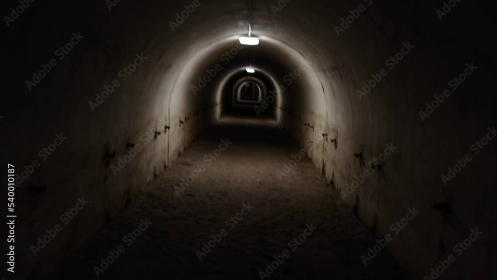 First person view walking through the military tunnel in the dungeon. Defensive structure, casemates. Bomb shelter during the war. First person view walking through the military tunnel in the dungeon. Defensive structure, casemates. Bomb shelter during the war.