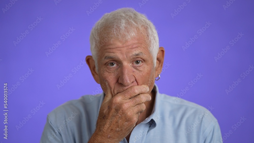 Closeup of elderly senior handsome man thinking searching for idea, isolated on a purple solid background. Closeup of elderly senior handsome man thinking searching for idea, isolated on a purple solid background.