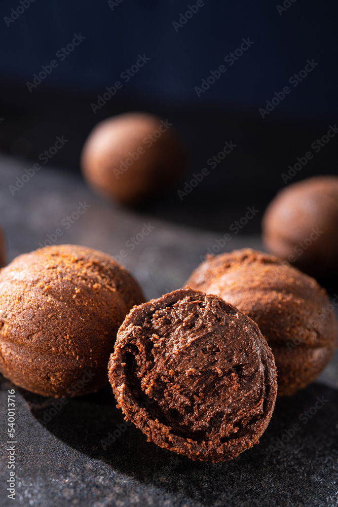 Tasty chocolate balls on a stone dark table. Tasty chocolate balls on a stone dark table.