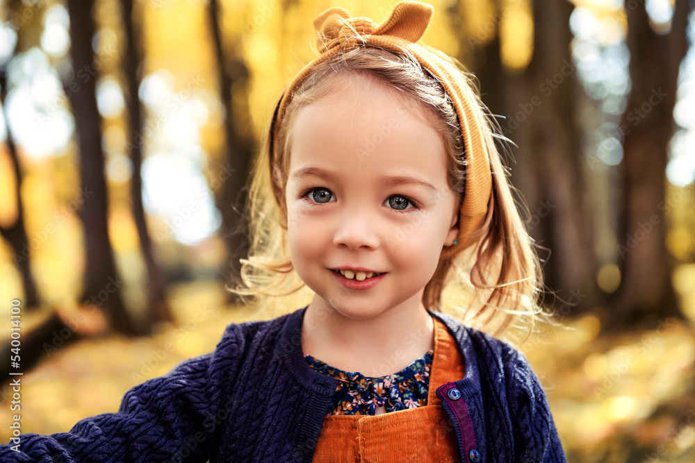 Adorable two years old girl enjoying nice and sunny autumn day outdoors Adorable two years old girl enjoying nice and sunny autumn day outdoors
