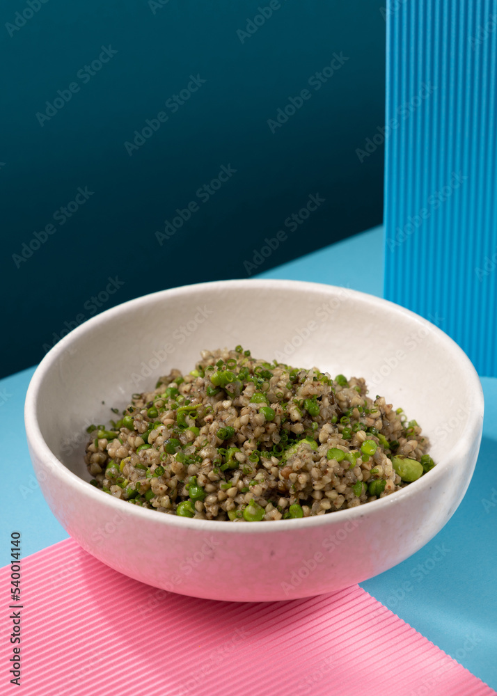 buckwheat porridge with broccoli on a blue background buckwheat porridge with broccoli on a blue background