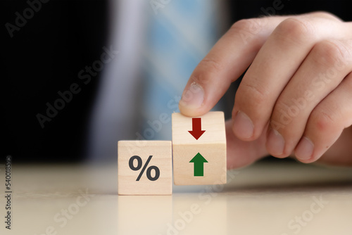 Business and finance concept.  Economic and business analysis, risk management. Interest rate, stocks, financial, ranking, mortgage and loan rates. Wooden cubes with percent, up or down arrow icons.