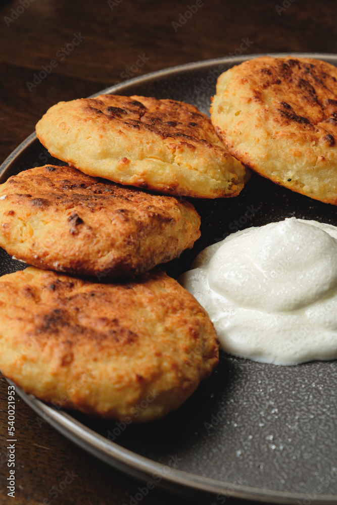 Cottage cheese pancakes,curd fritters with sour cream in a dish. Gourmet Breakfast
