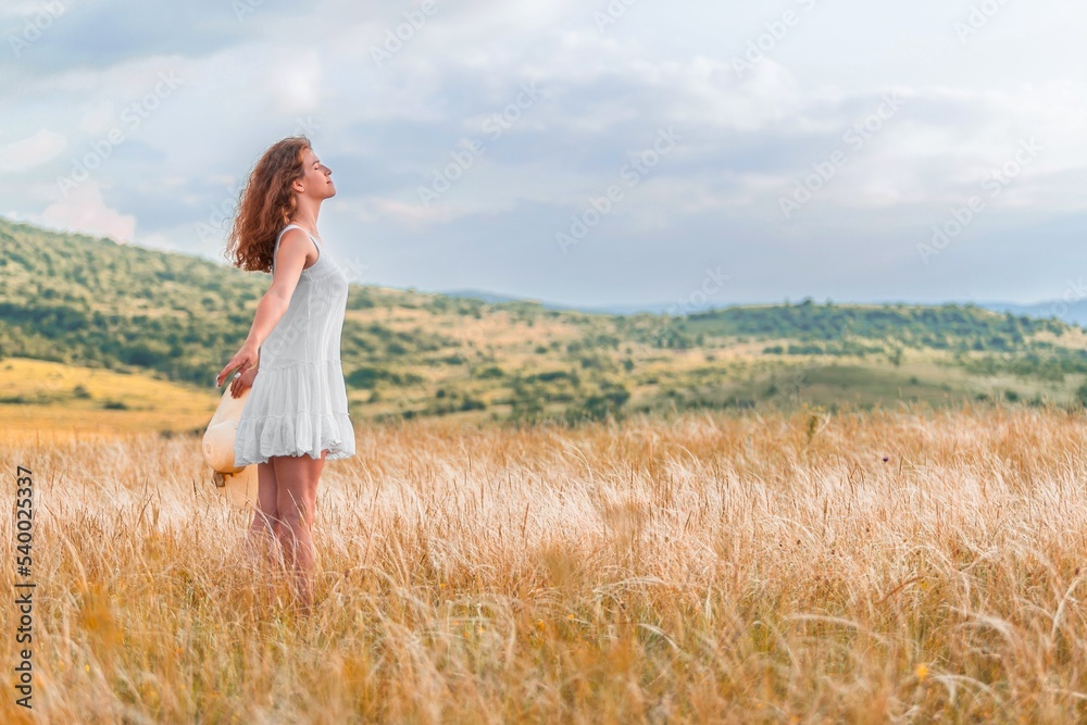 Woman in a hat on field wheat background Woman in a hat on field wheat background