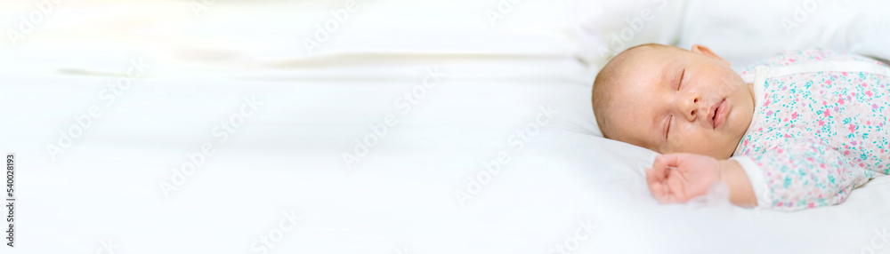 Newborn baby sleeps on a white bed. Selective focus. Newborn baby sleeps on a white bed. Selective focus.