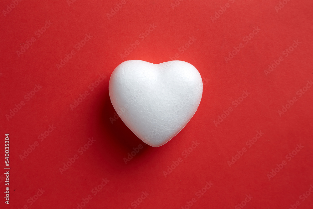 Love shape make from Styrofoam board isolated on red background Love shape make from Styrofoam board isolated on red background