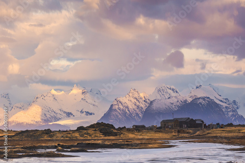 Snowy mountains and black sand beach on cloudy day