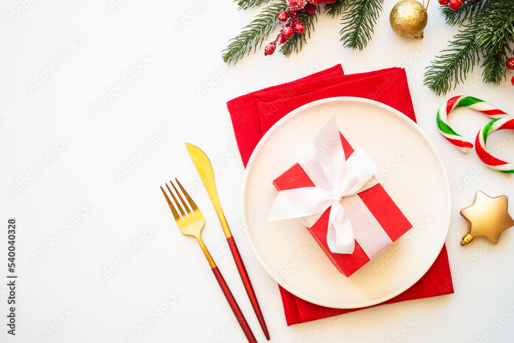Christmas table setting with white plate and christmas decorations on white background. Christmas table setting with white plate and christmas decorations on white background.