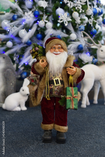 Santa Claus with gifts in the store
