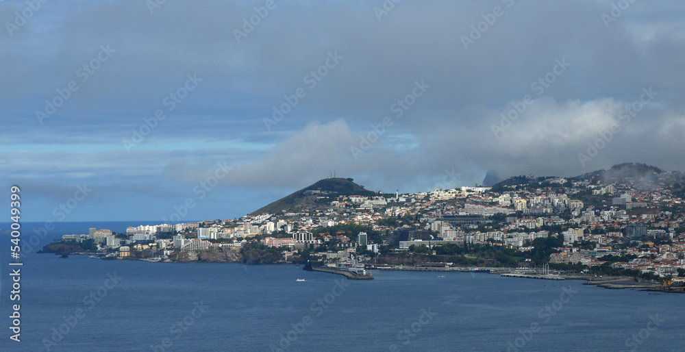 View of Clouds over Funchal Madeira seafront ocean and mountains