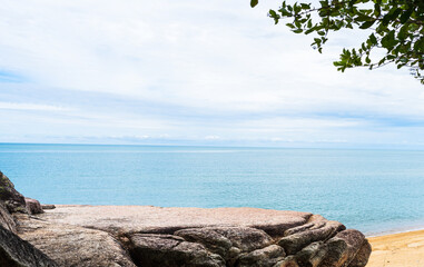 Rock stone stage in nature with sand beach seashore landscape and blue sky background well editing montage display product tourism 