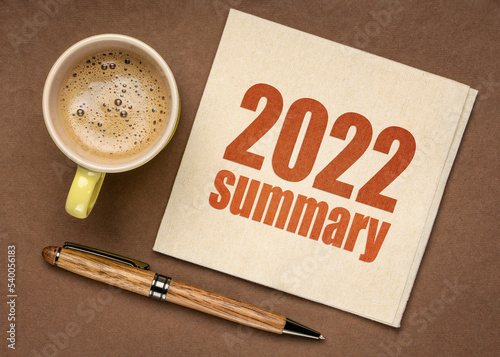 2022 year summary text on a napkin with a cup of coffee, end of year business concept