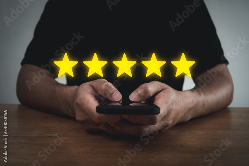 Satisfaction. people hand using mobile smart phone with five star button to review good rating, feedback, digital marketing, good experience, customer product rating review, customer feedback concept