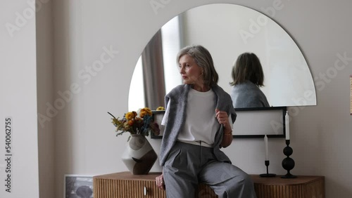 half-length portrait of fifty year old stylish woman in home interior