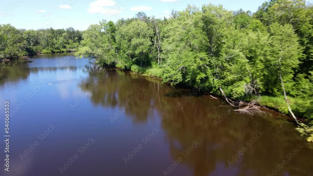 Flying over a river surounded by forest in Minnesota. Flying over a river surounded by forest in Minnesota.