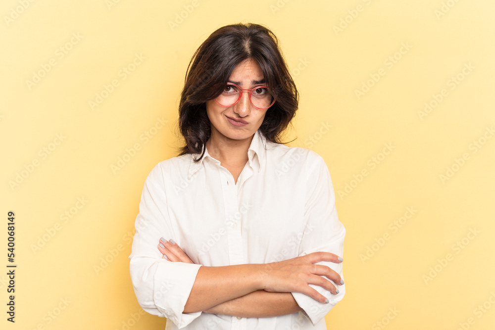 Young Indian woman isolated on yellow background unhappy looking in camera with sarcastic expression. Young Indian woman isolated on yellow background unhappy looking in camera with sarcastic expression.