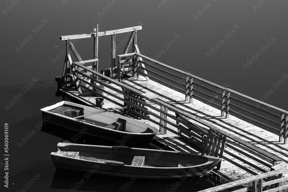 Two old wooden boats moored to the pontoon