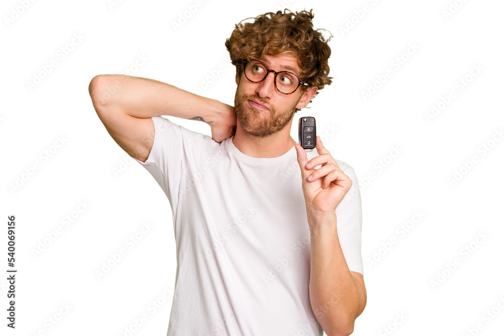 Young caucasian man holding car keys isolated on white background touching back of head, thinking and making a choice. Young caucasian man holding car keys isolated on white background touching back of head, thinking and making a choice.