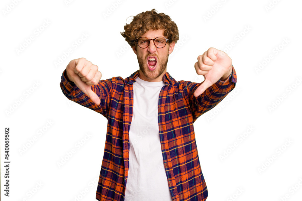 Young caucasian man isolated on green chroma background showing thumb down and expressing dislike.