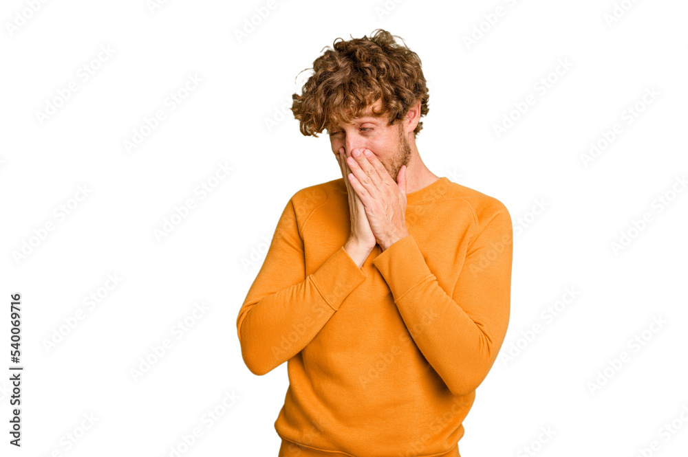 Young caucasian man isolated on green chroma background laughing about something, covering mouth with hands. Young caucasian man isolated on green chroma background laughing about something, covering mouth with hands.