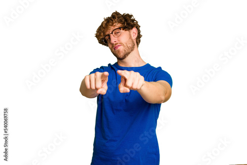 Young caucasian man isolated on green chroma background pointing to front with fingers.