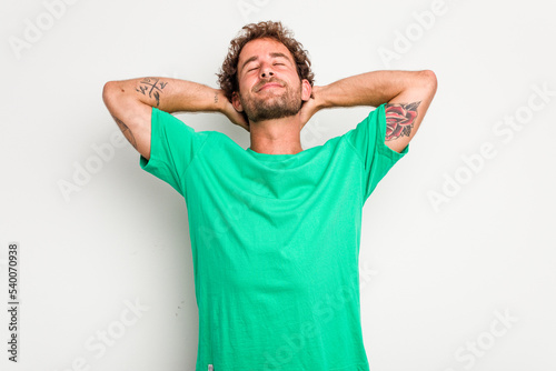 Young caucasian curly hair man isolated on white background feeling confident, with hands behind the head.