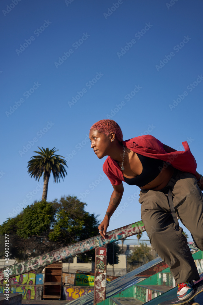 Portrait of young non-binary riding skateboard
