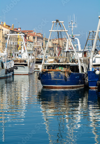 Big fishing boats moored in the port on the Adriatic sea at Chioggia city, Venetian lagoon, Venice province, northern Italy - october 30, 2021