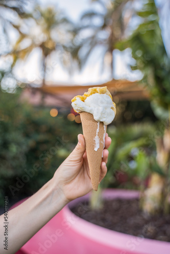 Close up view of the unrecognizable female person arm holding ice cream