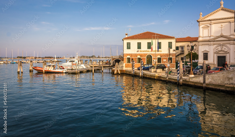Boat of the Guardia Costiera (Italian coastguard) moored near yachts in the harbour at Chioggia Venetian Lagoon, Veneto regione, Italy, Europe – october 30, 2021